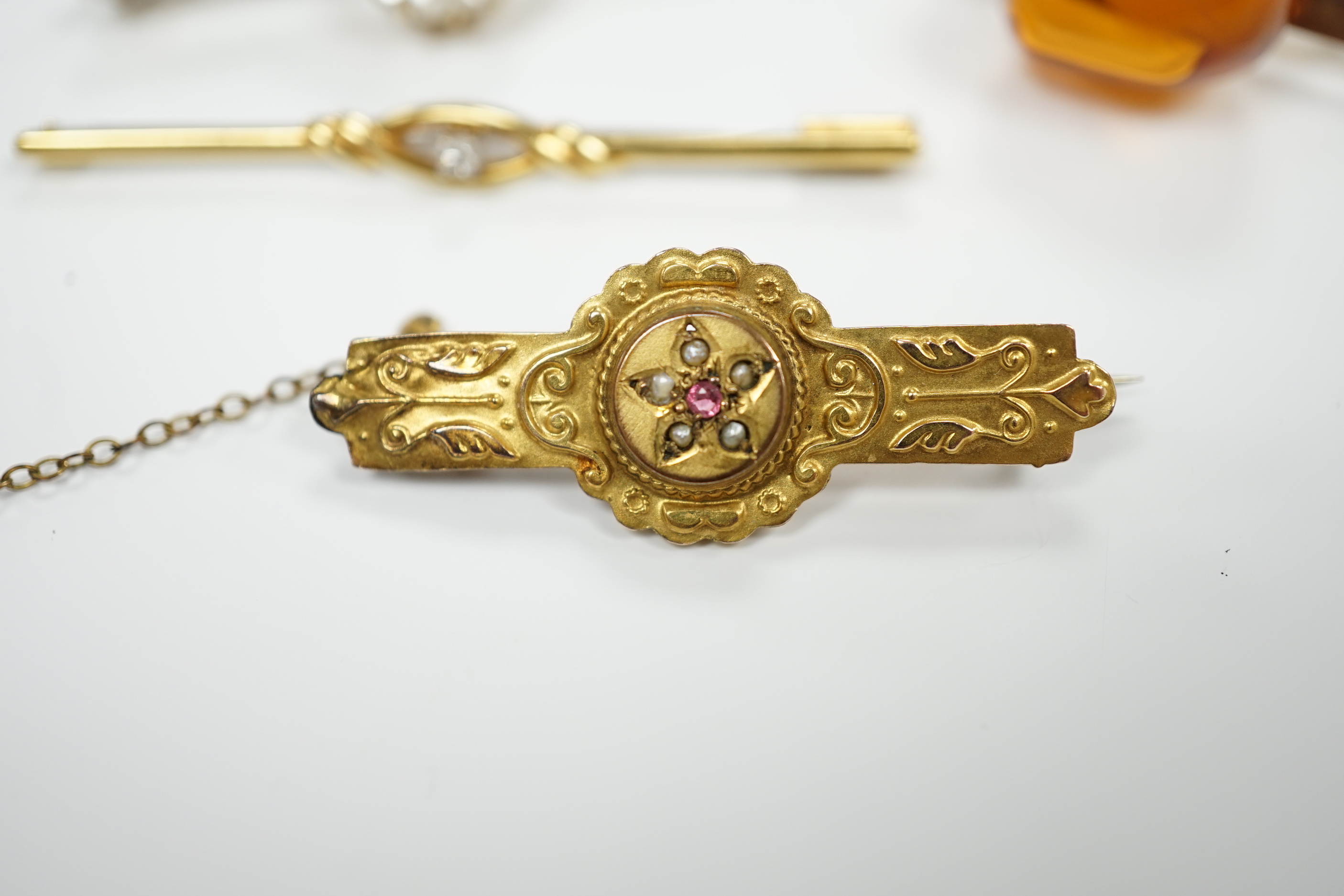 A 750 yellow metal and single stone diamond set bar brooch, 53mm, gross weight 2 grams and three other bar brooches including one 9ct gold and one yellow metal.